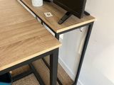 a desk with a tv on it and a chair in front of it