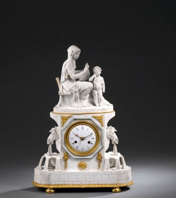 une horloge blanche et dorée surmontée d'une statue
