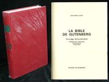 two books sitting next to each other on a black surface