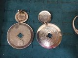 a pair of earrings that are sitting on a table