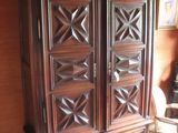 a large wooden cabinet in the corner of a room
