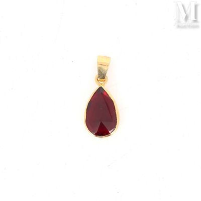 a close up of a red tear shaped pendant on a white background