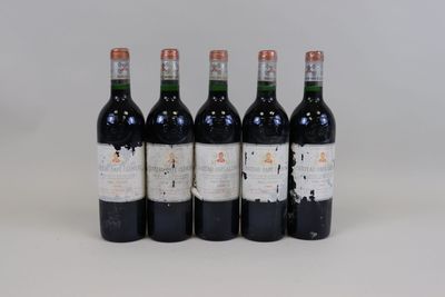 four bottles of wine are lined up on a white surface
