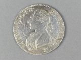 a close up of a silver coin with a woman ' s face on it
