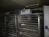 many trays of food that are on a conveyor belt
