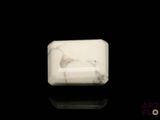 a white marble block on a black surface