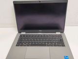 an open laptop computer sitting on top of a white table