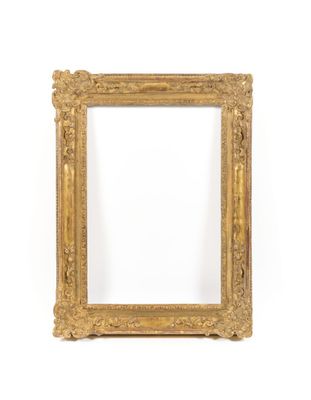 a gold picture frame on a white wall with a white background