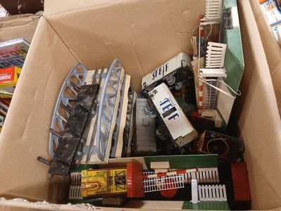 a cardboard box full of toy trains and other toys