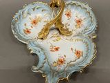 a blue and gold plate with a flower design on it