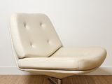 a white chair that is sitting in a room