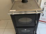 a stove that is sitting in the corner of a room