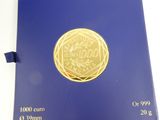 a gold coin sitting on top of a blue book