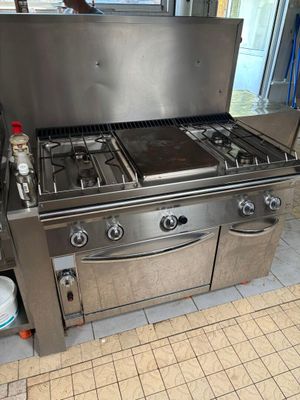 a large stainless steel stove in a commercial kitchen