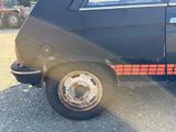 a black car with a red stripe on the side of it
