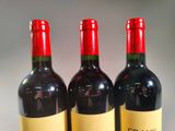 three bottles of wine sitting next to each other on a table