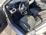 the interior of a car with the door open and the driver ' s seat down