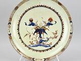 an image of a plate with a bird and flowers on it