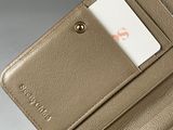 someone is holding a wallet with a card in it that has a credit card in it