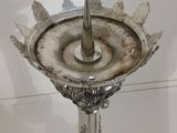 a silver plate with a candle on top of it