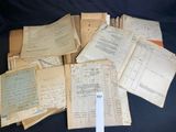 several old papers are stacked on top of each other on a black surface