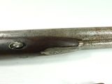 a close up of a gun on a white surface