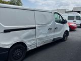 a white van that has been vandalized in a parking lot