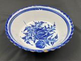 a close up of a blue and white bowl on a table