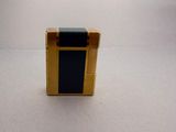 a small wooden box with a black top on a white surface