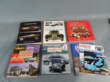 several books are sitting on a table with a cell phone next to them