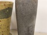two vases sitting next to each other on a table