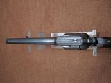 a close up of a gun on a brown surface