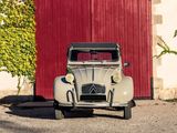 a old car parked in front of a red door