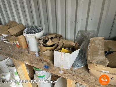 many boxes and buckets on a shelf in a storage area