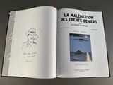 an open book with a drawing of a man in a hat