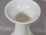two white vases sitting next to each other on a table