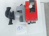 a red and black water pump on a white table