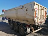 a dump truck that is parked on the side of the road