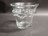 a glass vase with a handle on a table