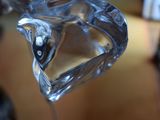 a glass vase with a liquid inside of it on a table