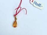 a small piece of glass with a red string attached to it