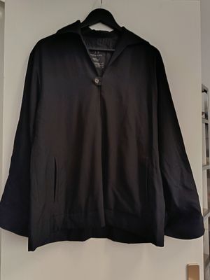 black jacket hanging on a white wall in a room