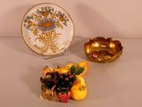 a plate and a bowl of fruit sitting on a table