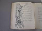 an open book with a drawing of an angel on it