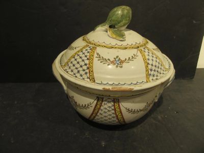 a bird sitting on top of a bowl on a table
