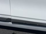 a white car with a black stripe on the side of it