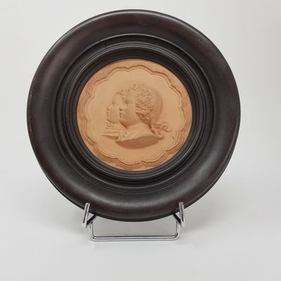an image of a brown plate with a picture of a woman on it