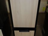 two black and white refrigerators with a sign on top of them