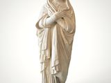 statue of a woman with a veil on her head and a crown on her head