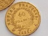four different types of gold coins sitting on top of a white surface